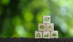 Stack of wooden blocks with green images of net-zero and other climate actions