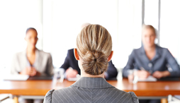 A women is interviewed by a panel