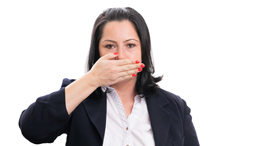 A woman abstains from voting on a topic by holding her hand over her mouth