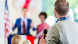 Man asks question during political meeting 