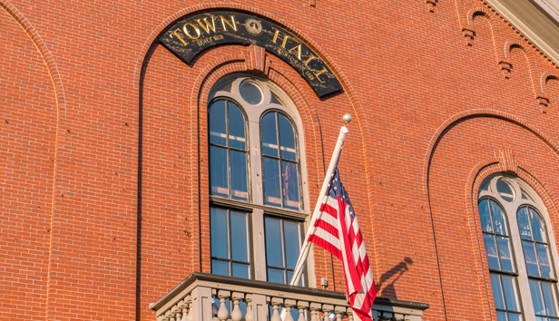 Exterior of a town hall with flag displayed