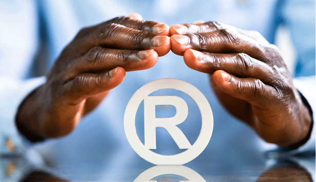 Hands are protecting a logo