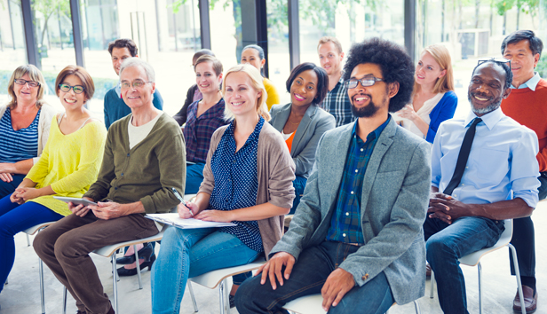 Diverse group of seated people participating in a meeting