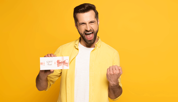 A man is excited to have received a gift card