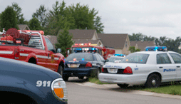 Several emergency vehicles are parked on a neighborhood street