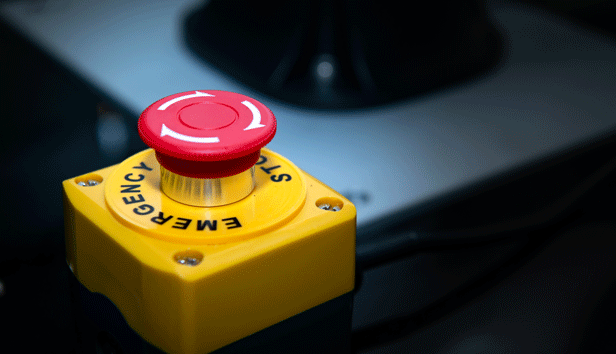 A red button on a yellow box labeled emergency