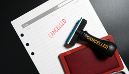 Red stamp labeled cancelled set against business to do list