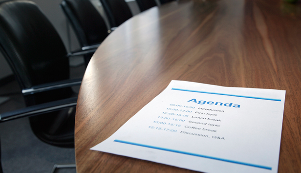 Blank agenda sitting on a meeting table