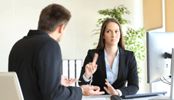 Woman gesturing 'no' to her colleague