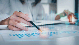 A close up of a person reviewing financial data